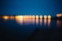 Kaboompics - Blurred city lights reflected in the water at night