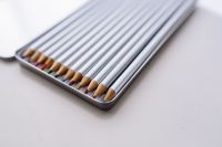 Kaboompics - Close-Up of Sharpened Colored Pencils in a Metal Tin