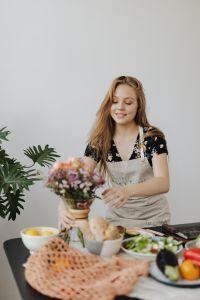 Kaboompics - Home Kitchen Scene with Woman, Flower Bouquet and Fresh Produce