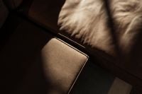 Kaboompics - Close-Up of Brown Leather Sofa Cushions in Moody Light