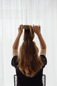 Kaboompics - Back View of Woman Brushing Hair with a Round Brush