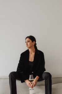 Kaboompics - Asian Woman Seated with a White Wine Glass in a Minimal Interior