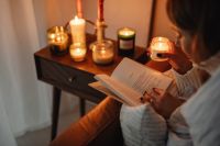 Kaboompics - Candlelit Still Life: Open Book and Glowing Jar Candles