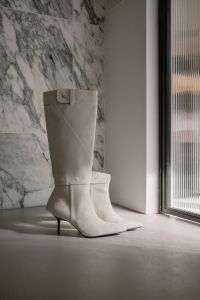 Kaboompics - White Knee-High Heeled Boots by Window