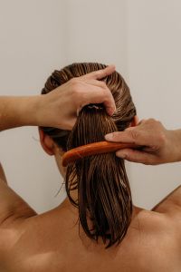 Kaboompics - Woman Combing Wet Hair in the Shower