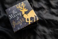 Kaboompics - Merry Christmas Card on Dark Bedding