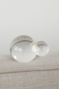 Kaboompics - Clear Glass Decorative Spheres on a Neutral Linen Background