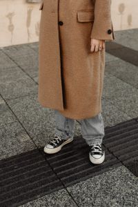 Kaboompics - Casual Camel Coat Outfit with Jeans and Black Sneakers