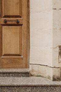 Kaboompics - Wooden Door and Pale Limestone Wall with Copy Space