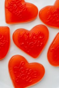 Kaboompics - Close-Up Orange Heart Gummies With Love Messages