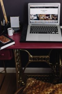 Kaboompics - Vertical MacBook Workspace on Vintage Singer Sewing Table