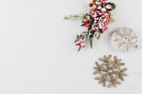 Kaboompics - Christmas Greenery with Red Berries and a Silver Snowflake on Marble