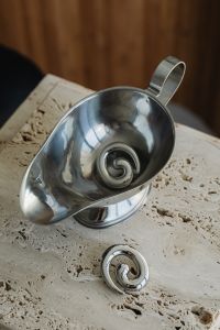 Kaboompics - Silver Spiral Earrings Arranged in a Bowl