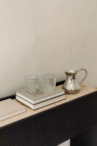 Kaboompics - Silver Pitcher and Two Clear Glasses on Travertine Console