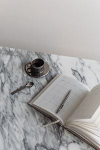 Kaboompics - Chrome Coffee Cup and Planner on Arabescato Marble