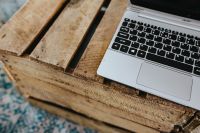 Kaboompics - Silver laptop on a wooden box table
