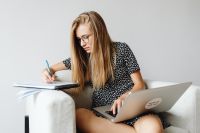 Kaboompics - Student Writing Notes beside Laptop