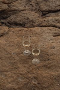 Kaboompics - Elevated View of Two Wine Glasses on a Pale Rocky Shore