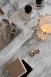 Kaboompics - Minimalist UGC-Inspired Jewelry Display on Marble Surface with Elegant Packaging