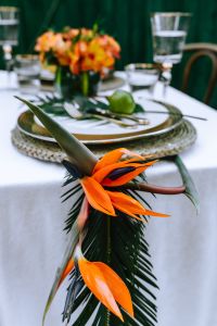 Kaboompics - Bird of Paradise Flower over Tropical Table Setting with Glassware