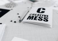 Kaboompics - Close-Up of Creative Mess Typography Notebook with Pen and Coffee Beans