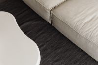 Kaboompics - Close-Up of White Coffee Table and Dark Textured Rug