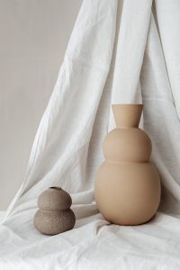 Kaboompics - Two Beige Ceramic Vases on Linen with Neutral Copy Space