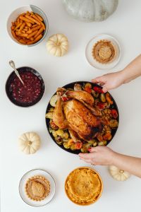 Thanksgiving Dinner Feast with Roast Turkey, Cranberry Sauce, Pumpkin Pie and Traditional Holiday Side Dishes