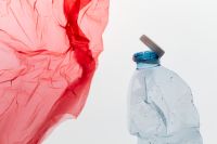 Kaboompics - Red Plastic Bag And Bottle Environmental Concept