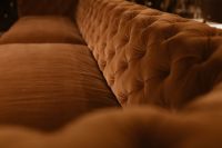 Kaboompics - Orange Velvet Sofa Seat Beside Deeply Button-Tufted Back
