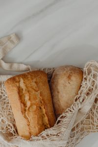 Kaboompics - Reusable Mesh Bag of Bread on a Marble Counter with Copy Space