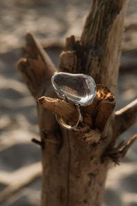 Kaboompics - Two Silver Rings Styled on Driftwood with Soft Beach Copy Space