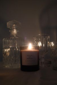 Kaboompics - Burning Amber Candle with Crystal Glassware