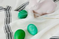 Kaboompics - Close-Up of Ceramic Bunny and Green Eggs on Linen