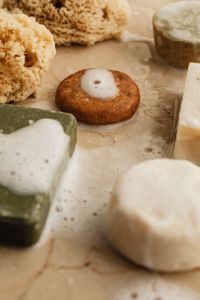 Kaboompics - Natural Soap Bars and Sea Sponges on a Wet Stone Surface