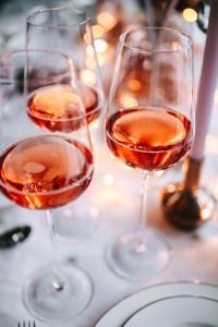Kaboompics - Two Rose Wine Glasses with Silver Christmas Decorations