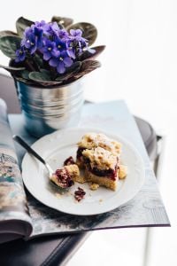 Flowers in a pot with a cake and a book