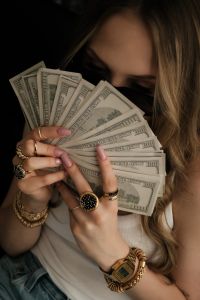 Kaboompics - Woman Hiding Behind Dollar Bills Money Vision Board