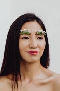Kaboompics - Asian Woman Portrait with Floral Eyebrows and a Clean White Background