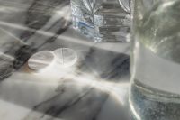 Kaboompics - Two White Tablets on Marble Beside Water Glasses