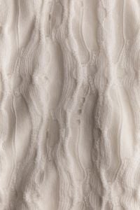 Kaboompics - Cream Cable Knit Fabric With Wavy Pattern