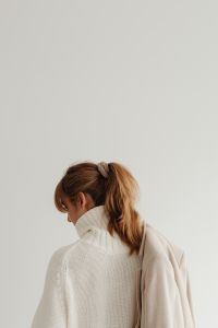 Kaboompics - Faceless Woman in White Sweater with Beige Coat from Behind