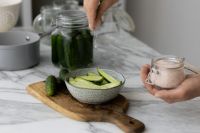 Kaboompics - Sliced Cucumbers with Salt Jar and Pickling Ingredients on Marble Counter