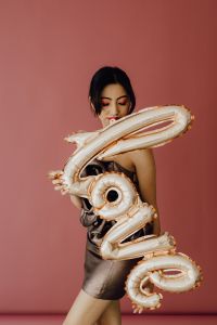 Kaboompics - Fashion Model Holding Gold LOVE Balloon Letters