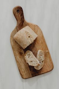 Kaboompics - Bread Slices Arranged on a Wooden Paddle Board
