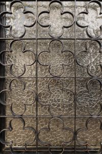 Kaboompics - Decorative Iron Grille over Textured Stone