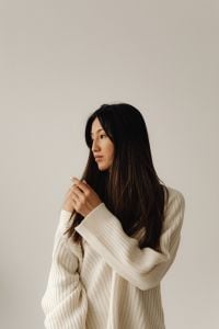 Kaboompics - Close-Up Side Portrait of a Woman in Cream Knitwear Looking Away