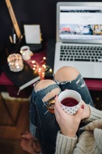 Woman drinking hot tea in her home office