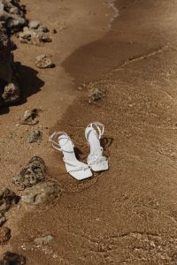 Kaboompics - White Heeled Sandals at the Waterline with Small Waves