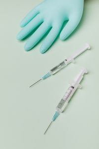 Kaboompics - Nitrile Glove and Two Syringes on Pale Mint Background